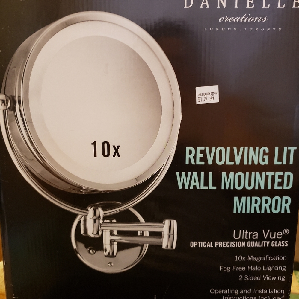 Revolving lit wall mounted mirror